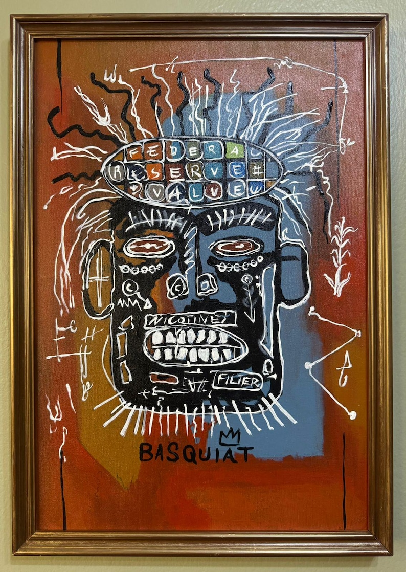 May include: Framed artwork featuring a stylized face with a black head and white teeth. The artwork includes the text "FEDERAL RESERVE VALUE" and "NICOTINE" and the artist's signature "BASQUIAT". The background is a mix of orange, blue, and white.