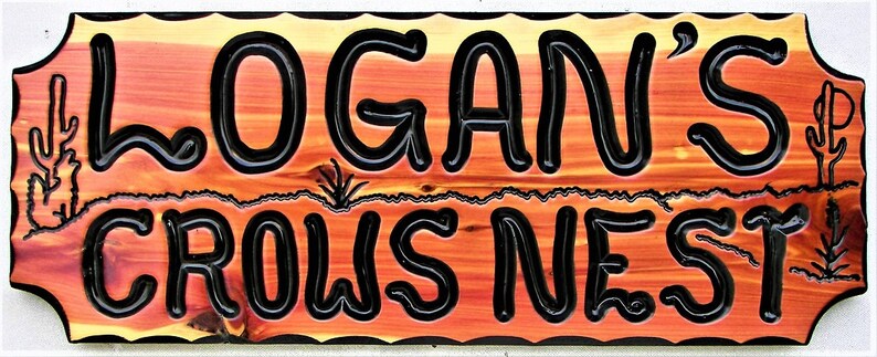 May include: A wooden sign with a rustic, orange-brown finish. The sign has a wavy, scalloped edge and features the text "LOGAN'S CROWS NEST" in black, raised lettering.