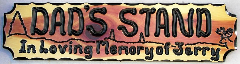 May include: A wooden sign with the text "Dad's Stand In Loving Memory of Jerry" in black lettering. The sign has a rustic, natural wood grain and a brown background with a red-brown swirl in the center.
