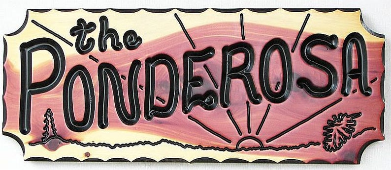 May include: A wooden sign with a rustic, reddish-brown background and a black border. The sign reads "the Ponderosa" in a stylized, black font. The sign also features a stylized sunrise and a small tree on the right side.
