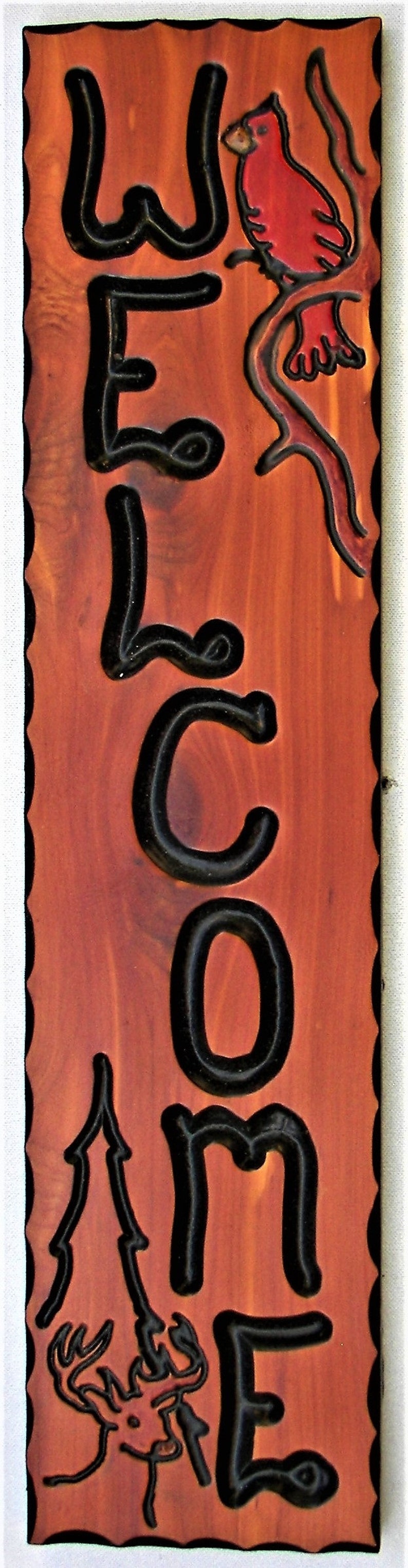 May include: Wooden sign with the word "WELCOME" in black outlined letters. The sign has a red cardinal perched on a branch and a deer silhouette at the bottom.