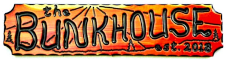May include: A red, orange, and yellow ceramic sign with the text "the BLINKHOUSE est. 2003". The sign has a wavy, rustic border.