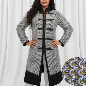May include: A silver chainmail coat with black leather trim and buckles. The long-sleeved coat features a high collar and a knee-length hem. The coat is designed with a detailed chainmail pattern and is suitable for historical reenactments or costume events.