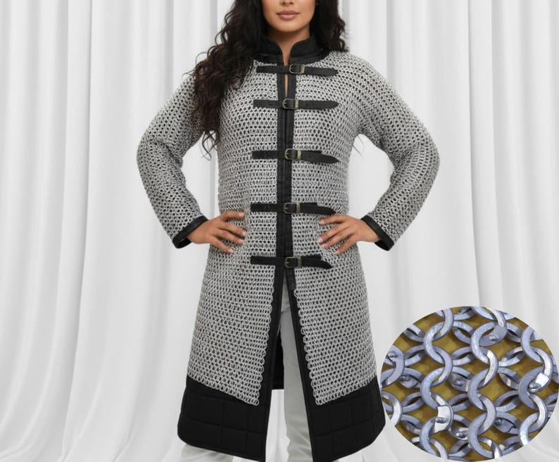 May include: A silver chainmail coat with black leather trim and buckles. The long-sleeved coat features a high collar and a knee-length hem. The coat is designed with a detailed chainmail pattern and is suitable for historical reenactments or costume events.