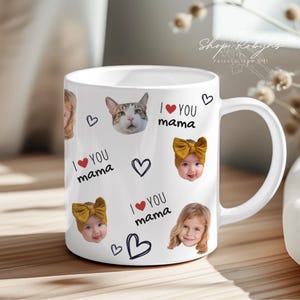May include: White ceramic mug featuring the text "I ❤️ YOU mama" with heart and cat graphics, and photos of children. The mug also has the Shop Robyns logo.