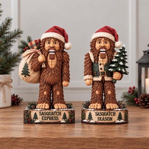 May include: Two Sasquatch nutcracker figurines wearing red Santa hats. The left figure carries a sack with a tree print and is on a base labeled "SASQUATCH EXPRESS". The right figure holds a small pine tree and is on a base labeled "SASQUATCH SEASON".