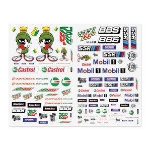 May include: A sticker sheet featuring various automotive and cartoon decals. It includes multiple images of Marvin the Martian, along with brand logos such as BBS, Castrol, Mobil 1, SSR, Raybrig, Nitrous Outlet, and Mountain Dew in various sizes.