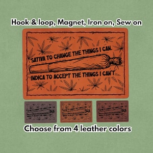 Könnte beinhalten: Orangener Lederaufnäher mit einer Cannabis-Joint-Illustration und dem Text "SATIVA TO CHANGE THE THINGS I CAN. INDICA TO ACCEPT THE THINGS I CAN'T." Optionen: Klettverschluss, Magnet, zum Aufbügeln oder Aufnähen. Wählen Sie aus 4 Lederfarben.