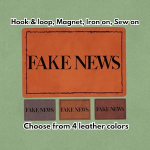 Pode incluir: Remendo de couro laranja com as palavras "FAKE NEWS" em letras pretas. Abaixo, três remendos menores em tons de marrom, cada um com o mesmo texto. O texto "Choose from 4 leather colors" está na parte inferior.
