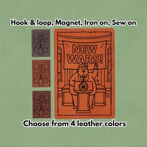 May include: Leather patches in various colours, featuring a cartoon illustration of a person speaking at a podium with the text "NEW WARS!". The patches are available with hook & loop, magnet, iron-on, or sew-on backing.