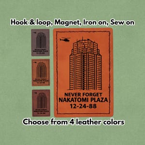 May include: Rectangular leather patches in four colors, featuring a skyscraper graphic and the text "NEVER FORGET NAKATOMI PLAZA 12-24-88." Options include hook & loop, magnet, iron-on, or sew-on.
