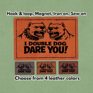 May include: Orange leather patch with two snarling dog illustrations and the text "I DOUBLE DOG DARE YOU!". The image also shows three smaller patches in different colors, and the text "Choose from 4 leather colors".