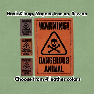 Pode incluir: Remendos de couro com um sinal de aviso com uma caveira e ossos cruzados, com a legenda "DANGEROUS ANIMAL". Os remendos estão disponíveis em quatro cores e podem ser fixados com velcro, ímã, passar a ferro ou costurar.