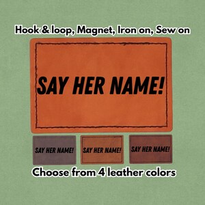 May include: Orange leather patch with the text "SAY HER NAME!" in bold black letters. The image also shows three smaller patches with the same text in different colors. The text "Choose from 4 leather colors" is also visible.
