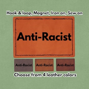 May include: Orange leather patch with the words "Anti-Racist" in bold black letters. The patch is available in four leather colors and can be attached with hook & loop, magnet, iron-on, or sew-on methods.