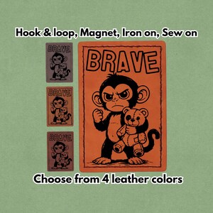 May include: Orange leather patch with a black illustration of a monkey holding a teddy bear, with the word "BRAVE" in large black letters. Three smaller patches are displayed, each with a monkey and teddy bear design. Text reads "Choose from 4 leather colors."