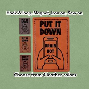 May include: Orange leather patch with the words "PUT IT DOWN" and "BRAIN ROT" printed on it, along with a graphic of a smartphone. The image also shows three smaller patches and text that says "Choose from 4 leather colors."