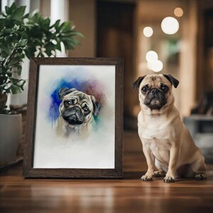 May include: A framed watercolor painting of a pug dog with a brown wooden frame. Beside the framed artwork, a live pug dog sits on a wooden surface. The painting has blue, purple, and yellow watercolor splashes.