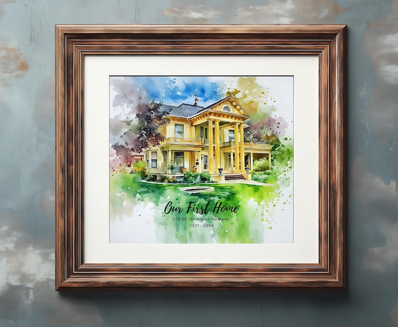 May include: A framed watercolor print of a yellow house with white columns, surrounded by green grass and colorful splashes. The text "Our First Home" is displayed, along with an address and dates. The frame is a dark brown color.