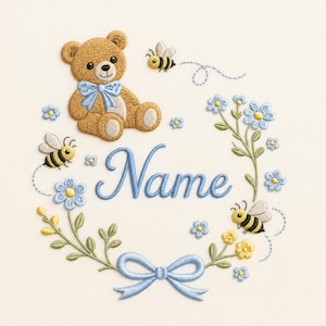 May include: Embroidered design featuring a teddy bear with a blue bow, surrounded by a floral wreath with blue flowers, bees, and a blue bow. The word "Name" is written in blue script. The design is on a cream-colored background.