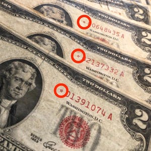 May include: Close-up of three vintage two-dollar bills. Each bill features a portrait of Thomas Jefferson and the text "TWO DOLLARS." The bills are from the Series of 1953, with serial numbers visible. The bills are slightly worn, showing signs of age.