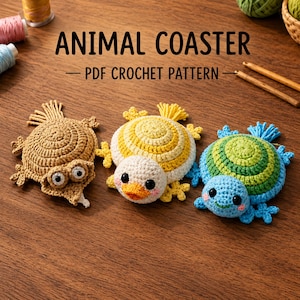 May include: Three crocheted animal coasters featuring a brown turtle, a yellow and white duck, and a green and blue turtle. The text ANIMAL COASTER PDF CROCHET PATTERN is displayed above the items, which are arranged on a wooden surface.