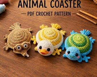May include: Three crocheted animal coasters featuring a brown turtle, a yellow and white duck, and a green and blue turtle. The text ANIMAL COASTER PDF CROCHET PATTERN is displayed above the items, which are arranged on a wooden surface.