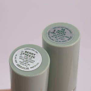 May include: Two cylindrical lipstick tubes with pale green caps. The silver labels on top display the text Clinique Labs, Dist. Berry Freeze Long Last Soft Shine Lipstick, Net Wt. .14 oz./4 g, Made in U.S.A., and other manufacturing information.