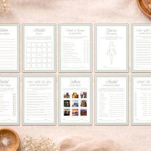 Op de afbeelding: Een set van tien witte bruidsdouche-spelkaarten met saliegroene randen en tekst. De kaarten bevatten titels zoals Advice for the Bride, Bridal Bingo, Bride or Groom Guess Who, Guess the Dress, How Well Do You Know the Bride, Bridal Over or Under, How Well Do You Know the Couple, Where Were They, Bridal Word Scramble en Would You Rather.