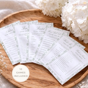 May include: A collection of bridal shower game cards with floral border designs. The cards include games like "Advice for the Bride," "Bridal Word Scramble," and "Would She This or That?" A circular sticker reads "10 Games Included."