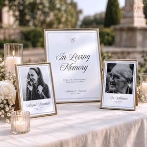May include: A memorial display featuring three gold-framed signs on a white cloth. The center sign reads In Loving Memory with names and date. Two smaller frames contain black and white portraits of Abigail Fairchild and Joe Williams.