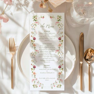May include: A menu card with floral border and text "the Menu" on a white plate, with gold cutlery. The menu lists starters, main courses, and desserts. The menu includes dishes like Smoked Salmon with Lemon and Dill, Roast Corn-Fed Chicken, and Strawberry Millefeuille.
