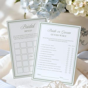 Op de afbeelding: Twee witte papieren spelkaarten met saliegroene randen. E&eacute;n kaart is getiteld Bridal Bingo met een raster voor cadeaus. De andere is getiteld Bride or Groom Guess Who? met twaalf genummerde vragen en cirkels om aan te vinken.