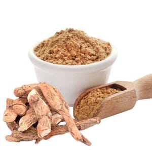 May include: A white bowl filled with brown powder, a wooden scoop with brown powder, and a pile of brown roots. The items are set against a white background. The powder appears finely ground, and the roots have a rough texture.