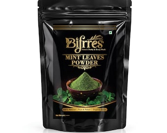 Può includere: Una busta nera in piedi contenente polvere di foglie di menta Bifrres. L'etichetta presenta testo dorato, un grafico di una ciotola marrone scuro riempita di polvere di menta verde e foglie di menta fresca. Include 'Bifrres', 'MINT LEAVES POWDER'.