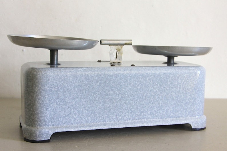 May include: A vintage gray kitchen scale with two metal bowls. The scale has a speckled gray finish and a metal base.