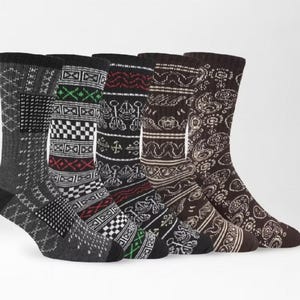 May include: A set of five crew-length socks featuring various knit patterns. The socks display black, gray, white, red, and green colors with geometric, checkered, and paisley designs. Each sock has a ribbed cuff and a reinforced heel and toe area.