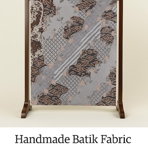 May include: Handmade Batik fabric with a Megamendung combination pattern, displayed on a wooden stand. The fabric features a unique design with brown and gray patterns, and is approximately 79 inches by 45 inches.