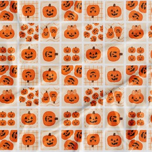 May include: A repeating pattern of orange pumpkins with carved faces and bows on a cream background. The pumpkins vary in size and design, creating a festive Halloween theme. Some pumpkins are on a grid.