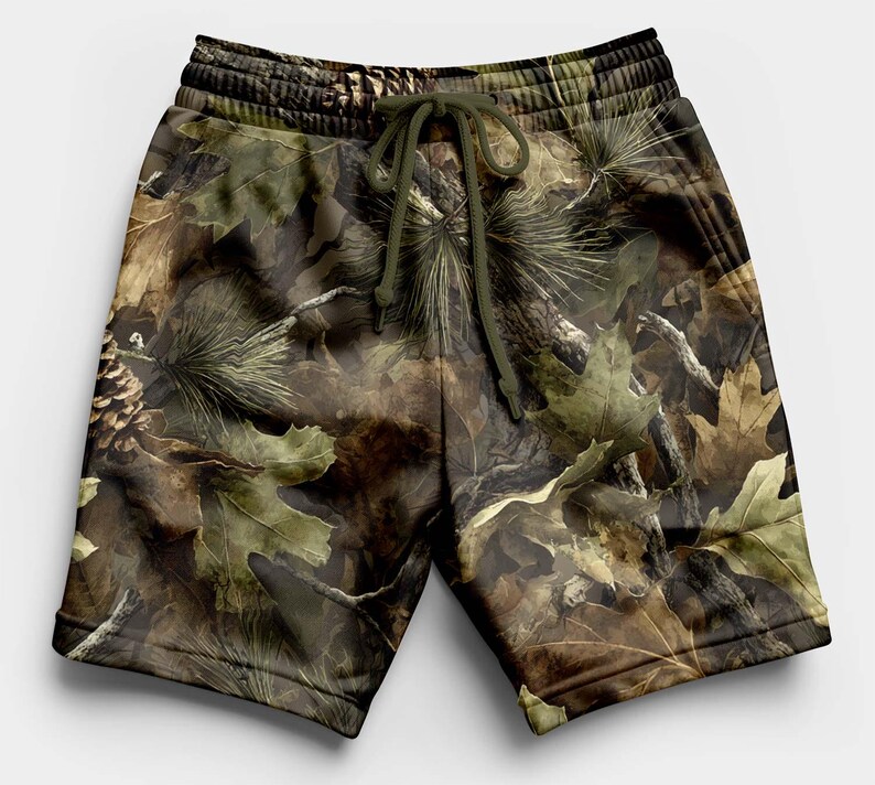 K&ouml;nnte beinhalten: Shorts mit Camouflage-Print und Kordelzug in der Taille. Die Shorts zeigen ein Muster aus Bl&auml;ttern, Kiefernnadeln und Tannenzapfen in Braun-, Gr&uuml;n- und Beiget&ouml;nen. Die Shorts sind aus einem weichen, bequemen Material gefertigt.