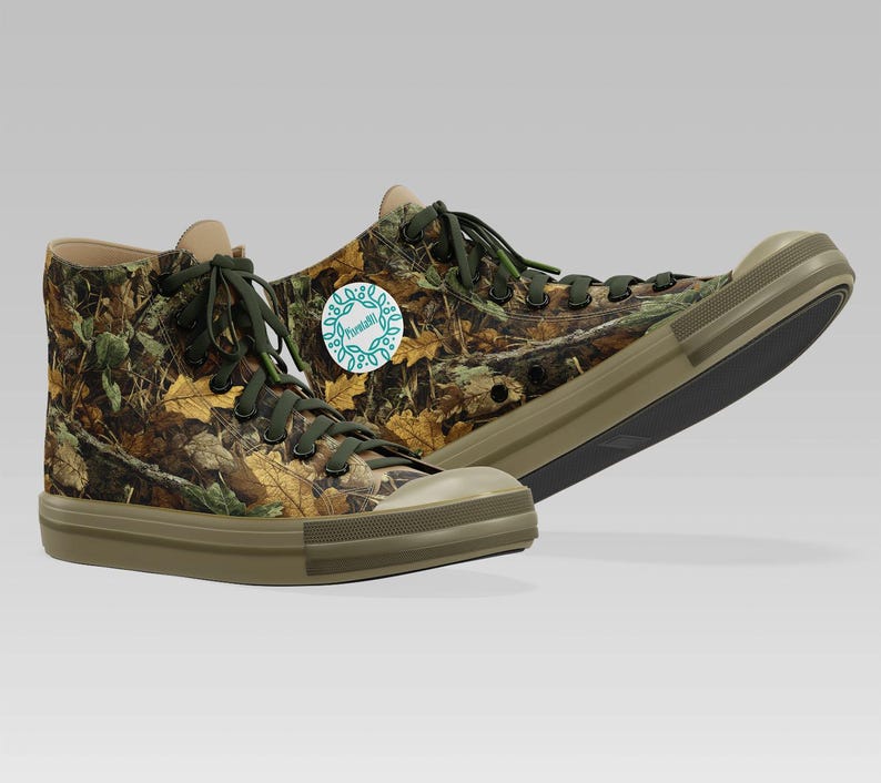 May include: High-top canvas sneakers with a camouflage pattern of brown, green, and yellow leaves. The sneakers have olive green soles, laces, and a round logo on the side. The shoes are designed for casual wear.