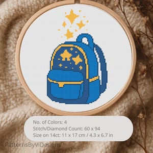 May include: Cross-stitch pattern of a blue backpack with yellow accents and stars, displayed in a wooden embroidery hoop. The pattern includes the text "No. of Colors: 4", "Stitch/Diamond Count: 60 x 94", and "Size on 14ct: 4.3 x 6.7 in".