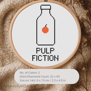 May include: Cross-stitch embroidery in a wooden hoop. The design features a black outline of a bottle with an orange fruit inside, and the words "PULP FICTION" in black. The size is 2.3 x 4.9 inches.