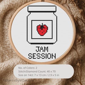 May include: A cross-stitch design in a wooden hoop features a jar with a red strawberry and the words "JAM SESSION." The design is 2.9 x 5 inches and uses two colors. The design is on a white background.