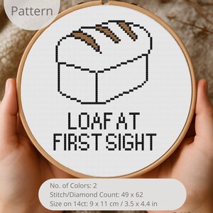 May include: A cross-stitch pattern in a wooden hoop features a pixelated loaf of bread with the text "LOAF AT FIRST SIGHT". The pattern includes the text "PDF Pattern" and details: 9 x 11 cm / 3.5 x 4.4 in. A craft project.