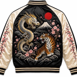 May include: A black satin bomber jacket with cream-coloured sleeves featuring striped ribbed cuffs and collar. The back displays an intricate embroidered scene of a dragon, a tiger, Mount Fuji, a red sun, and pink cherry blossom branches.