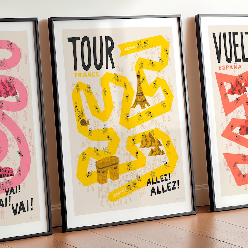 Set of three Grand Tour cycling posters—Giro, Tour, and Vuelta, focussing on the Tour design in the centre and with the Giro and Vuelta designs shown cropped on either side. The print is framed and leaning against a wall and features fun illustrations of a yellow race route on a neutral background, including riders, spectators and famous French landmarks.