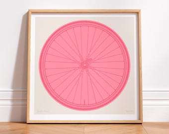 May include: A framed print of a pink bicycle wheel with a white background. The wheel is drawn in a simple line style.