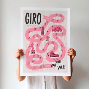 Unframed Giro Grand Tour cycling poster being held up, featuring a pink winding race path on a neutral background, including fun illustrations of riders, fans and a selection of famous Italian landmarks.