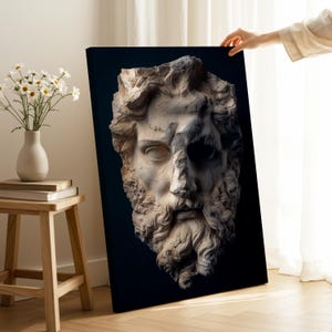 May include: A rectangular canvas print featuring a high-contrast, detailed stone sculpture of a bearded male face against a solid black background. The sculpture displays weathered textures, deep shadows, and intricate curls in the hair and beard.